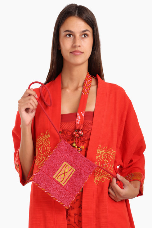 Small cross body bag with embroidered badge